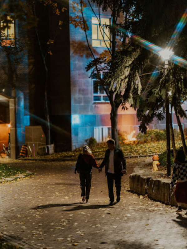 a man and a woman walking together holding hands 