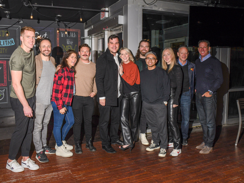 a group of friends posing together with a couple in the middle 
