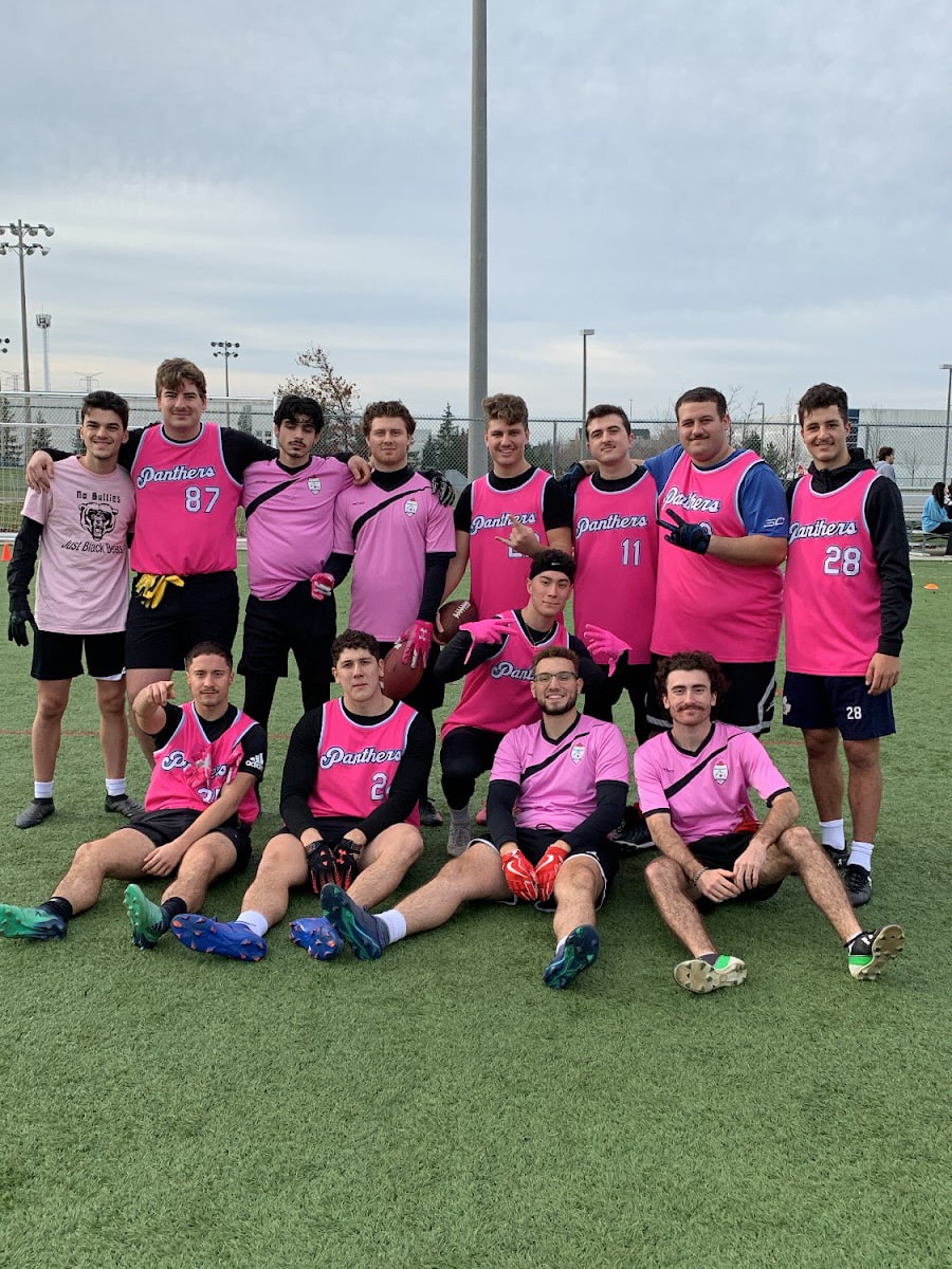 The team in pink jerseys pose for a picture