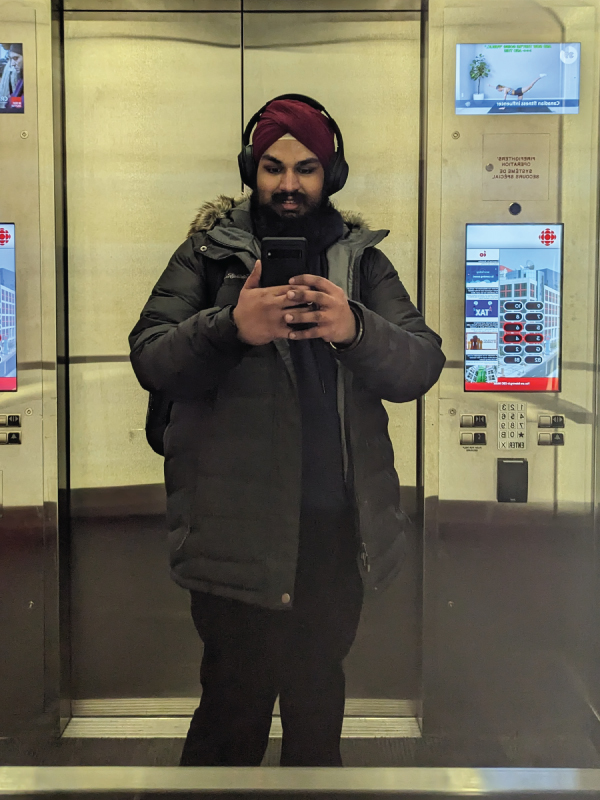 Kuwarjeet taking a mirror selfie in an elevator
