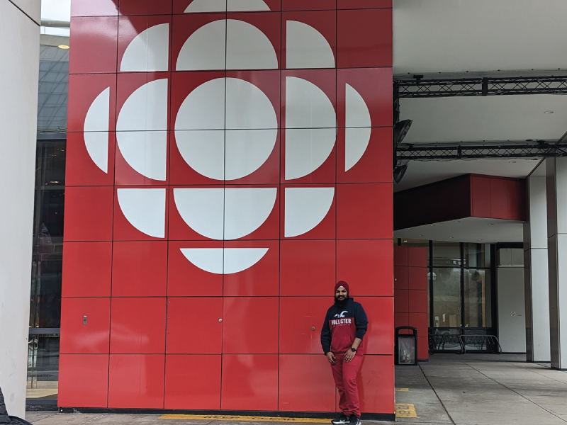 Singh posing in front of the CBC office