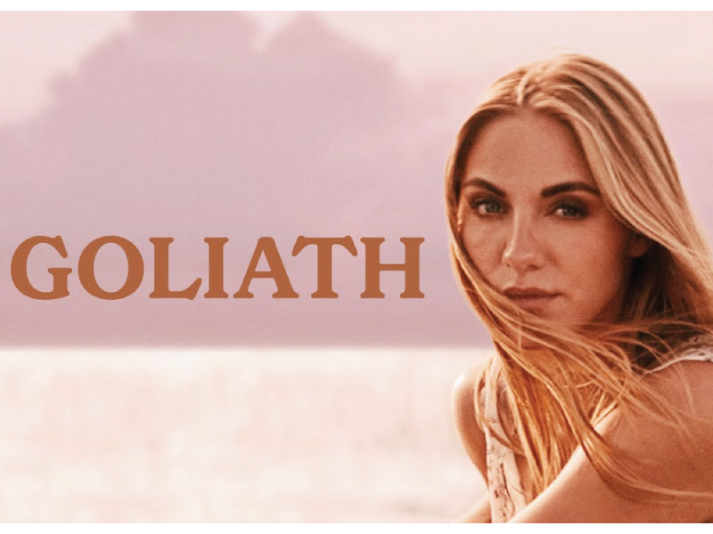 Pink graphic with the word 'goliath' in brown text