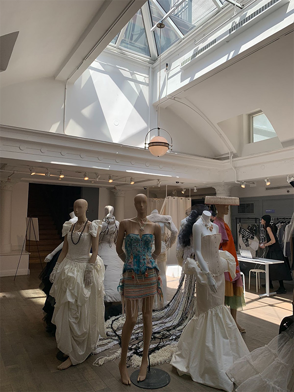 Mannequins placed in a circle showcasing students' work at INLAND