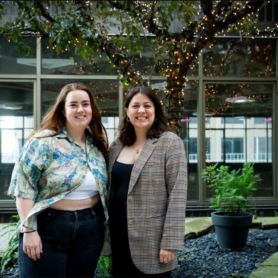 Michelle Forrester and Marileina Pearson standing together for a photo with a tree in the background