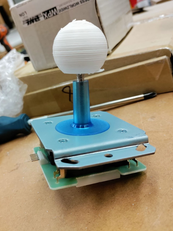 A newly constructed joystick is being prepared to be painted