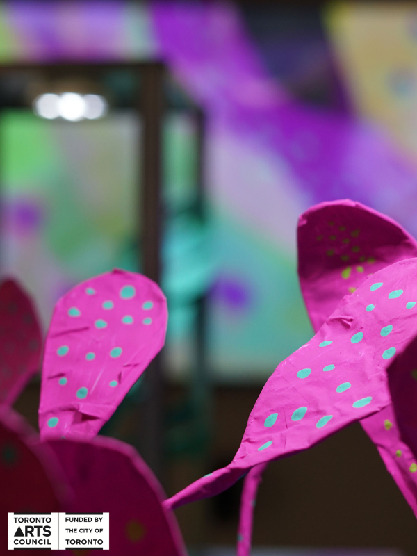 A close-up photo of the plant made our of paper mache that has been painted bright colours.