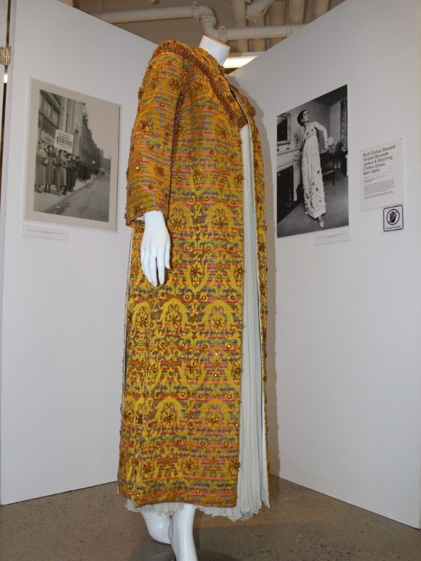 Mannequin wearing a Ruth Dukas beaded striped jacket and chiffon dress 