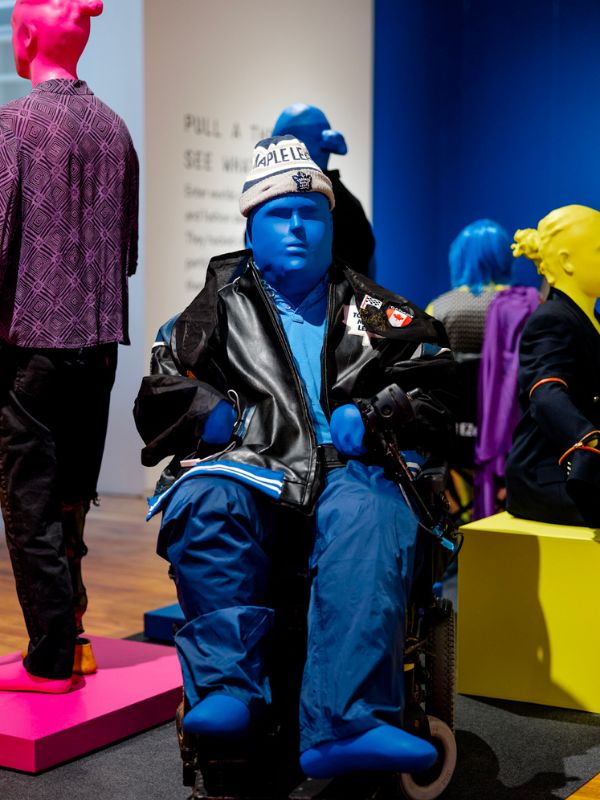 Mannequin of a disabled person on a wheel chair wearing Toronto Maple Leafs pants, jacket, and hat
