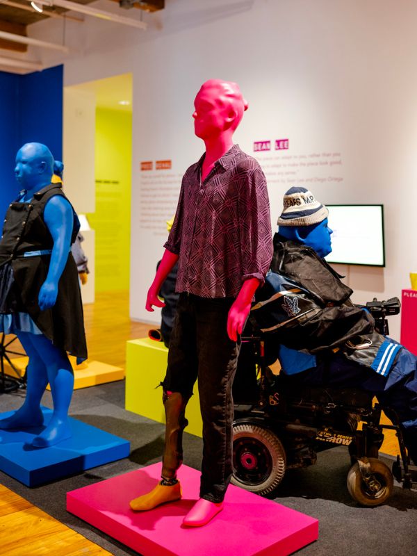 Pink mannequin wearing a magenta patterned shirt with black jeans 