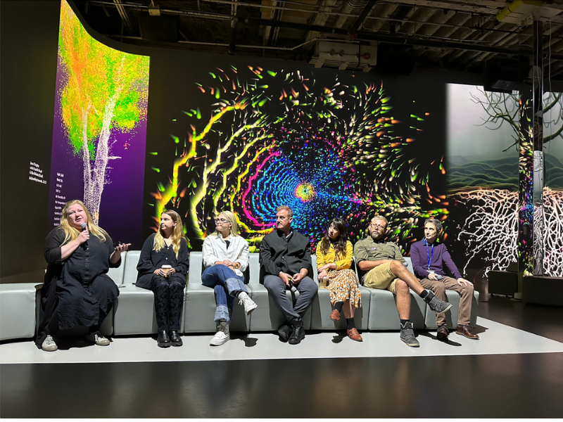 Seven people sitting on stage for a Digital Art Panel