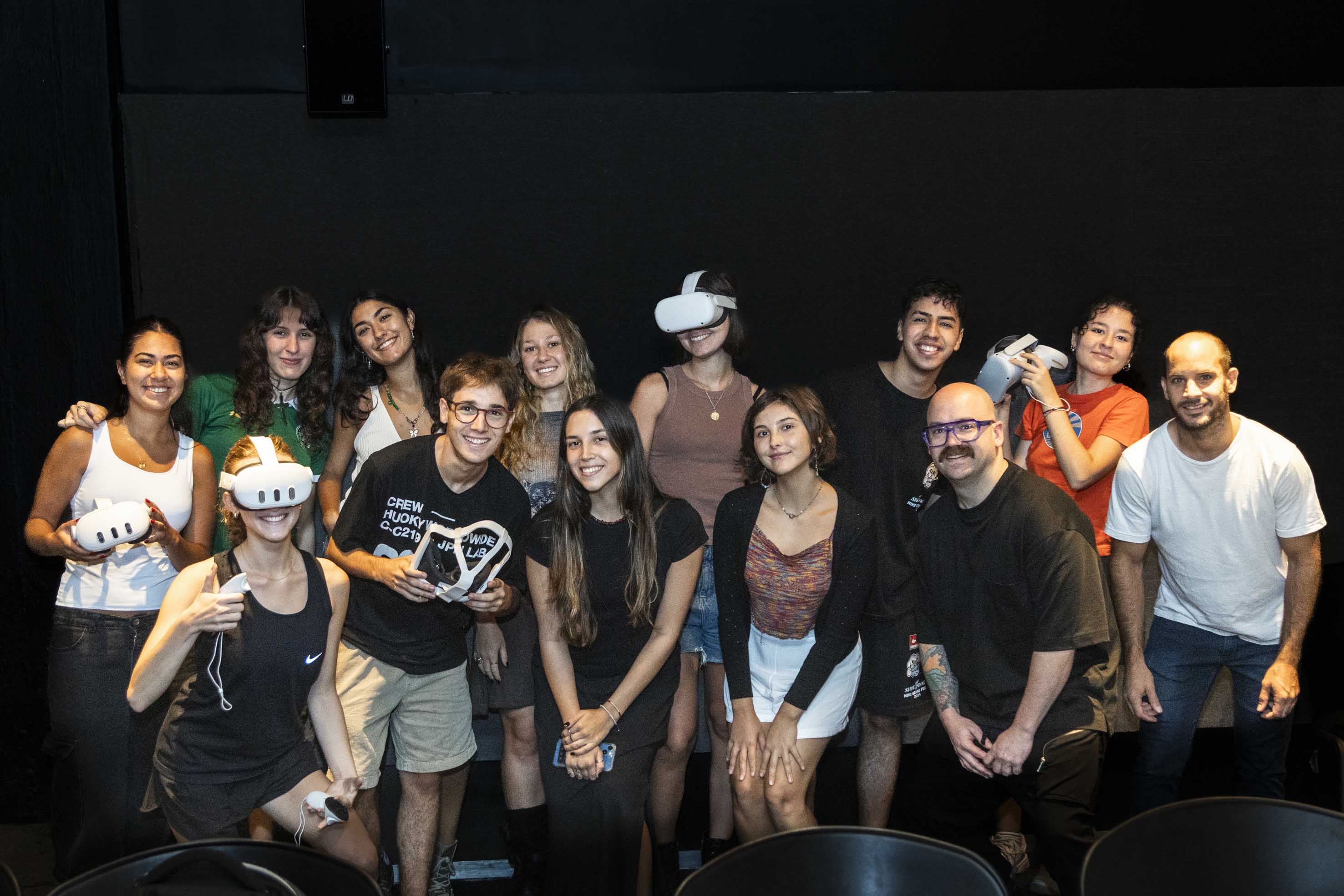 Group of students with smiles and VR sets.