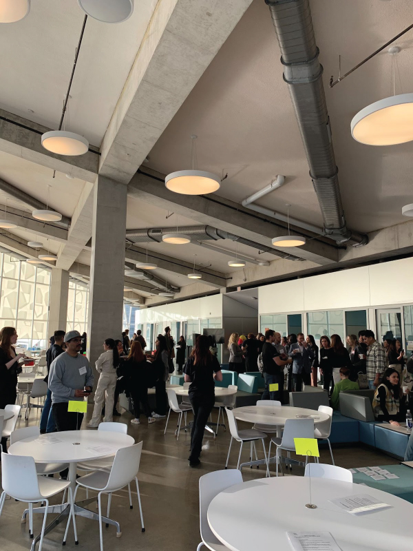 Attendees stand around the room talking to each other before the event began. 