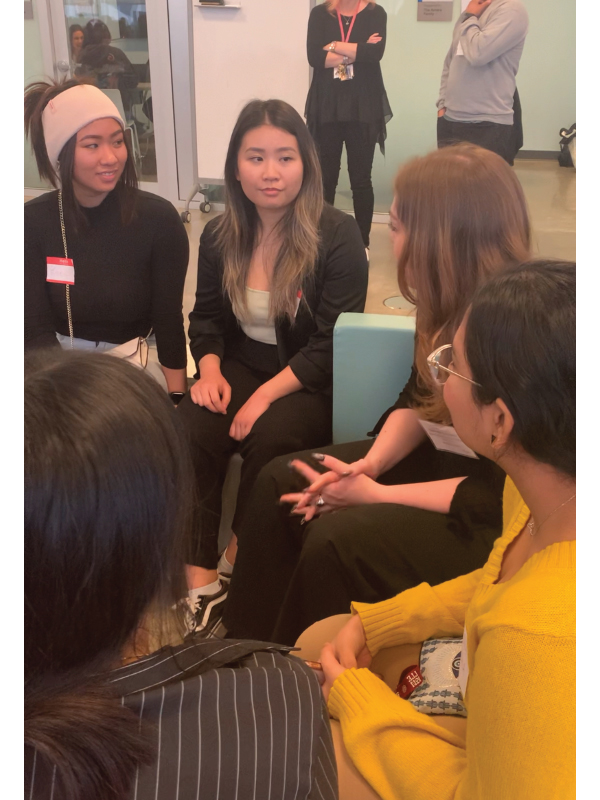 Four students and one industry guest are seated in a group during a speed networking session. 