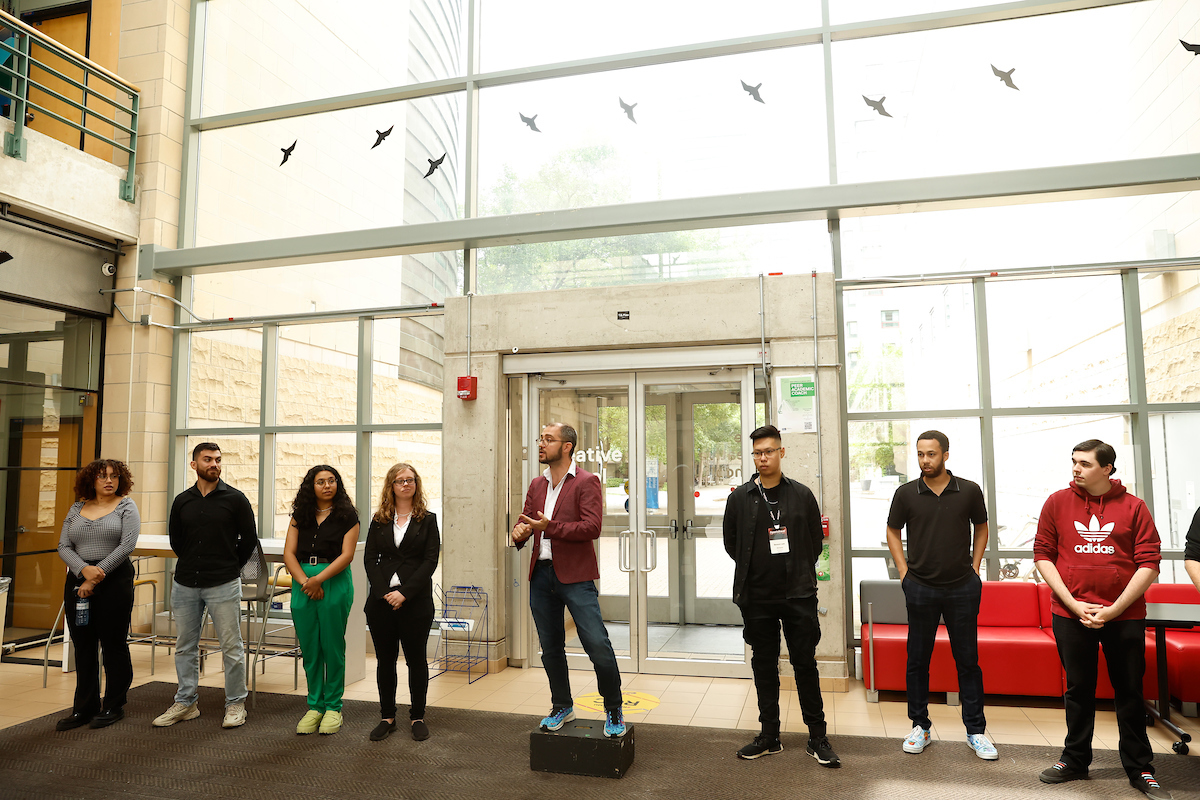 The Creative School students and Geoffrey Lachapelle are pictured in the lobby of the Rogers Communication Centre (RCC).