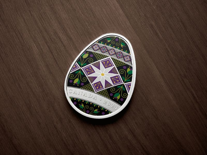 An egg-shaped coin decorated with purple, green, and silver colours and designs. 
