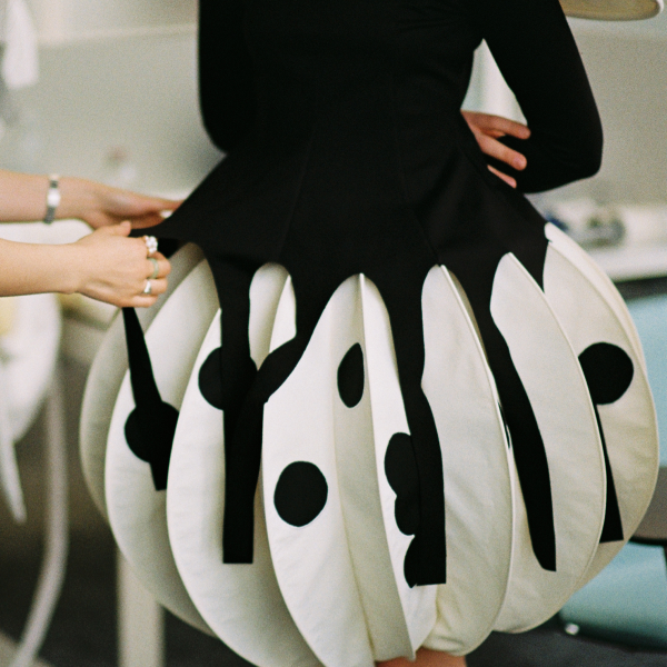 Medium close-up shot of a black and white dress with a bubble silhouette.