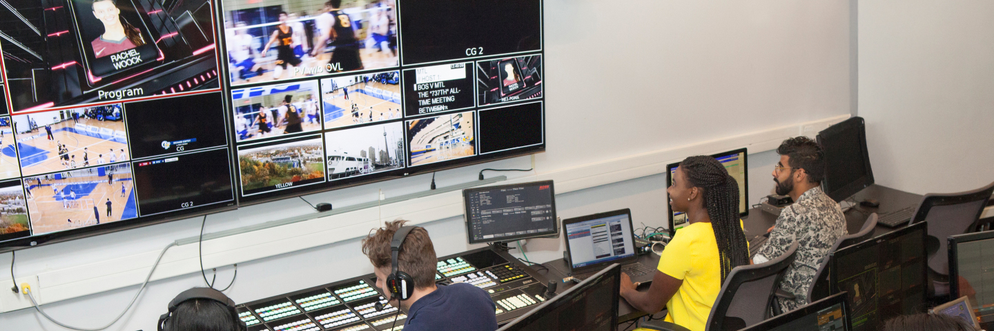 Students looking at screens with a live game production