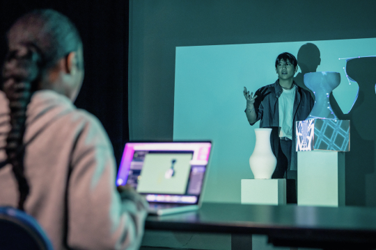 Students using computer software to project images on objects