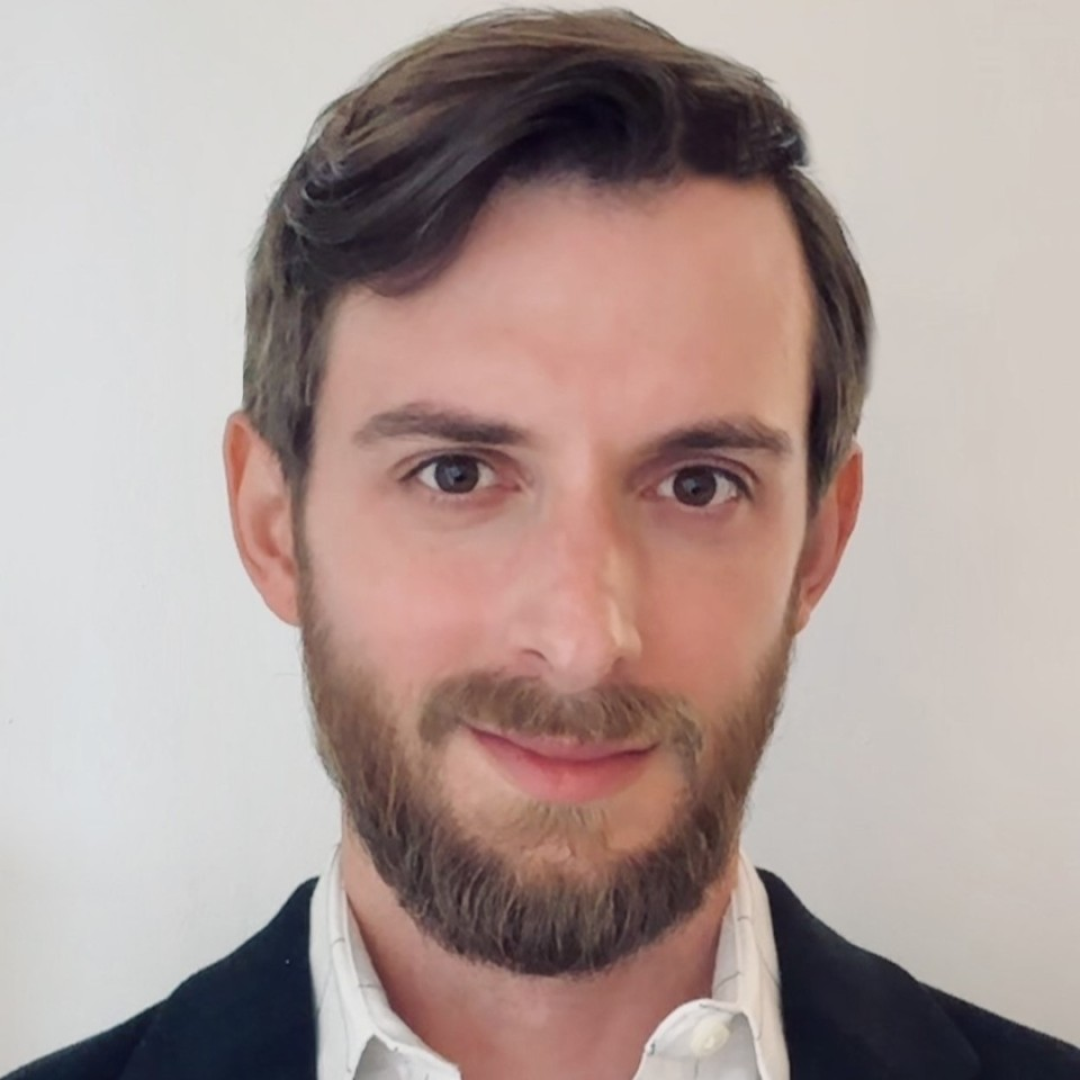 Headshot of Michael Turco wearing a business shirt and smiling