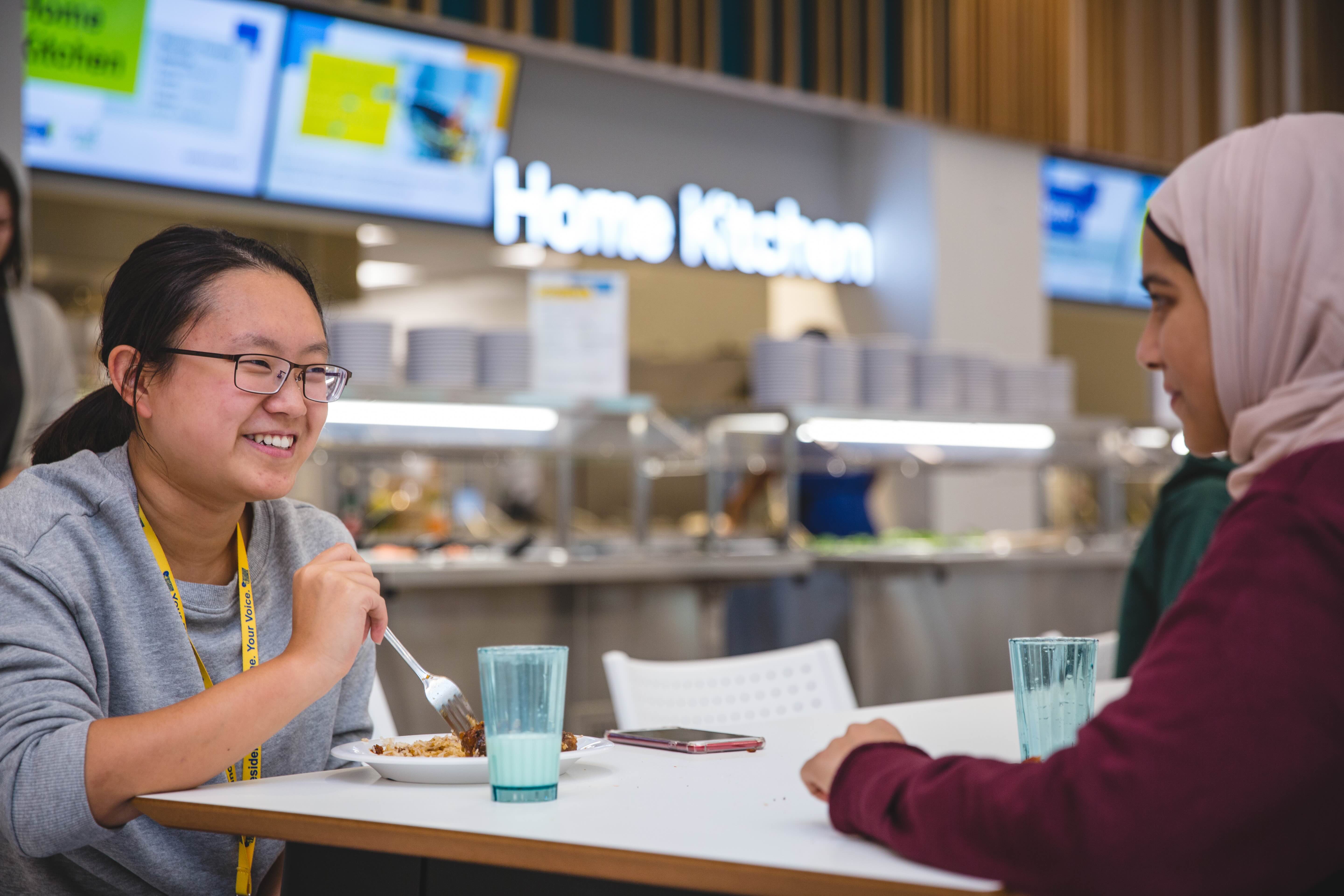 Two students eating a meal at pitman dining hall