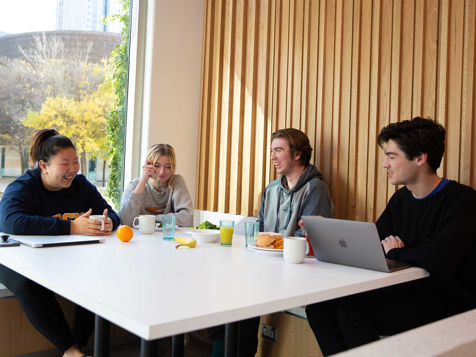 Students chatting and eating in the ILC dining hall.
