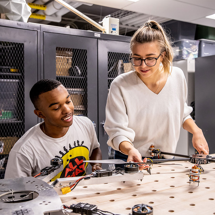 Two students working on a project in a tech lab