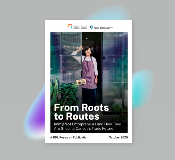 woman standing and smiling by the open store