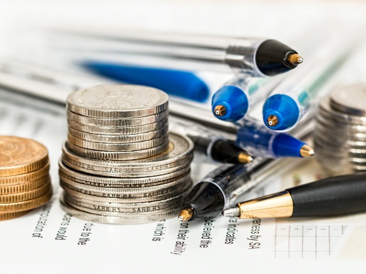 stacked coins and pens