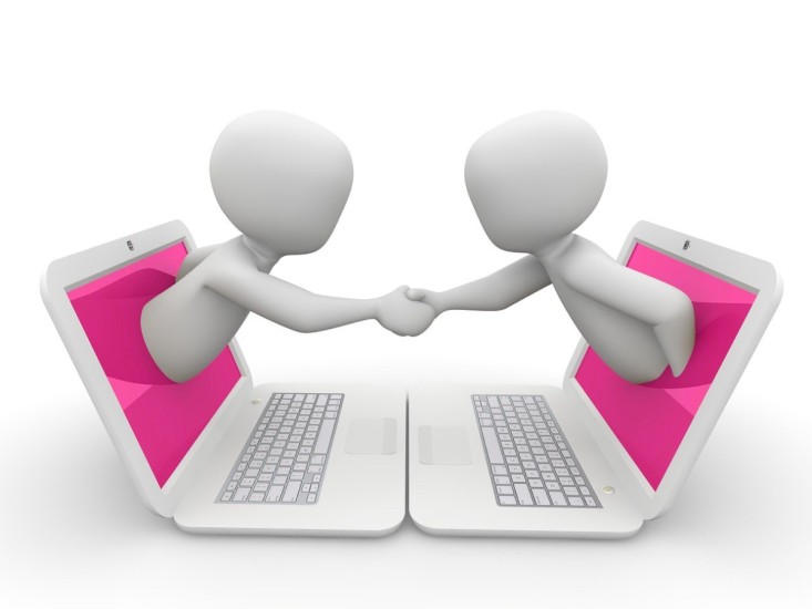 handshake from two laptops