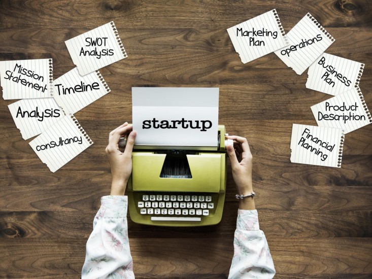 A person's hands holding a typewriter