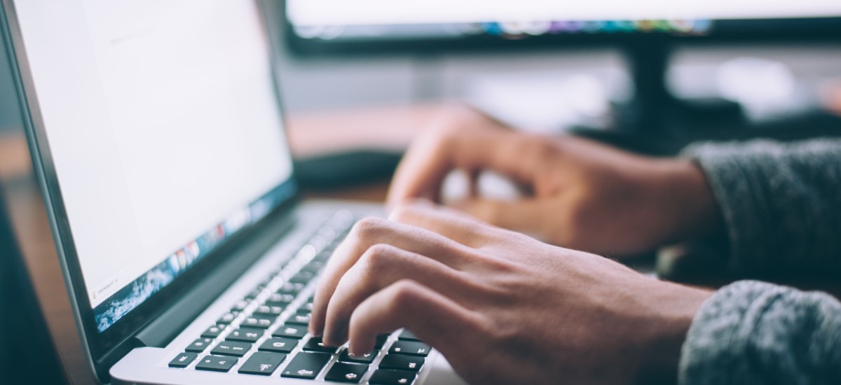 hands on laptop keyboard
