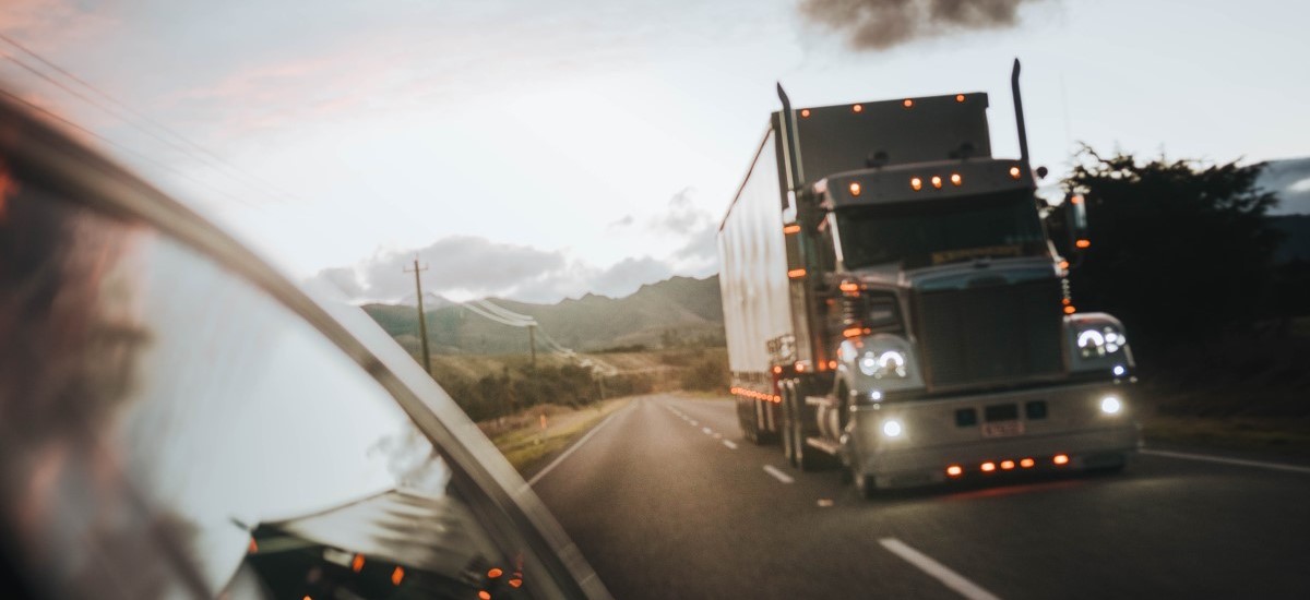truck on road under the cloudy sky