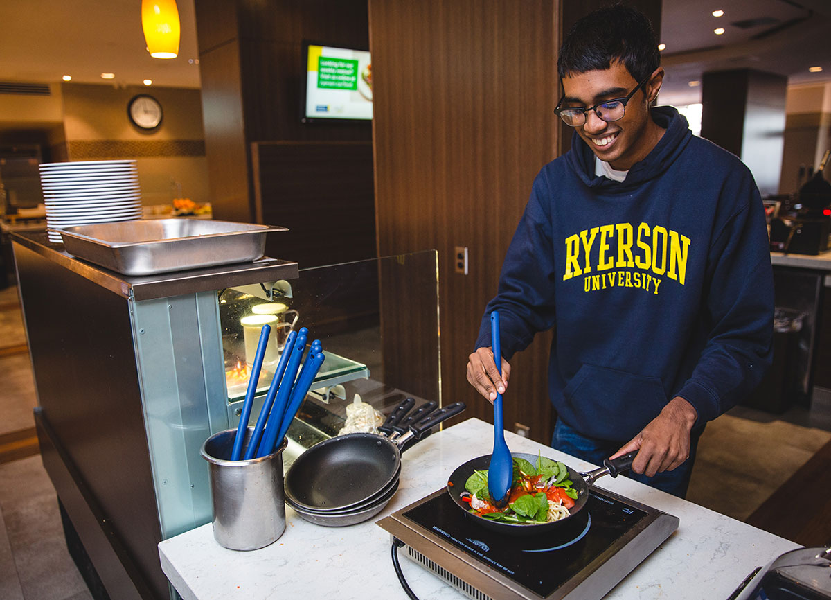 A student preparing their own meal at the ILC Dining Hall.