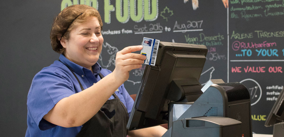 Food services worker swiping someones OneCard