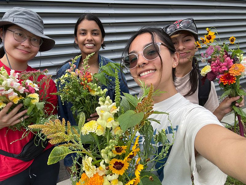 Students posing with their bouquets of flowers picked from the Urban Farm.