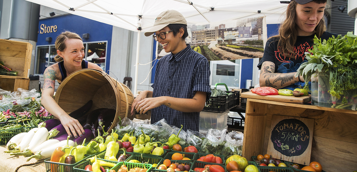 Urban Farm staff display fresh produce grown on campus.