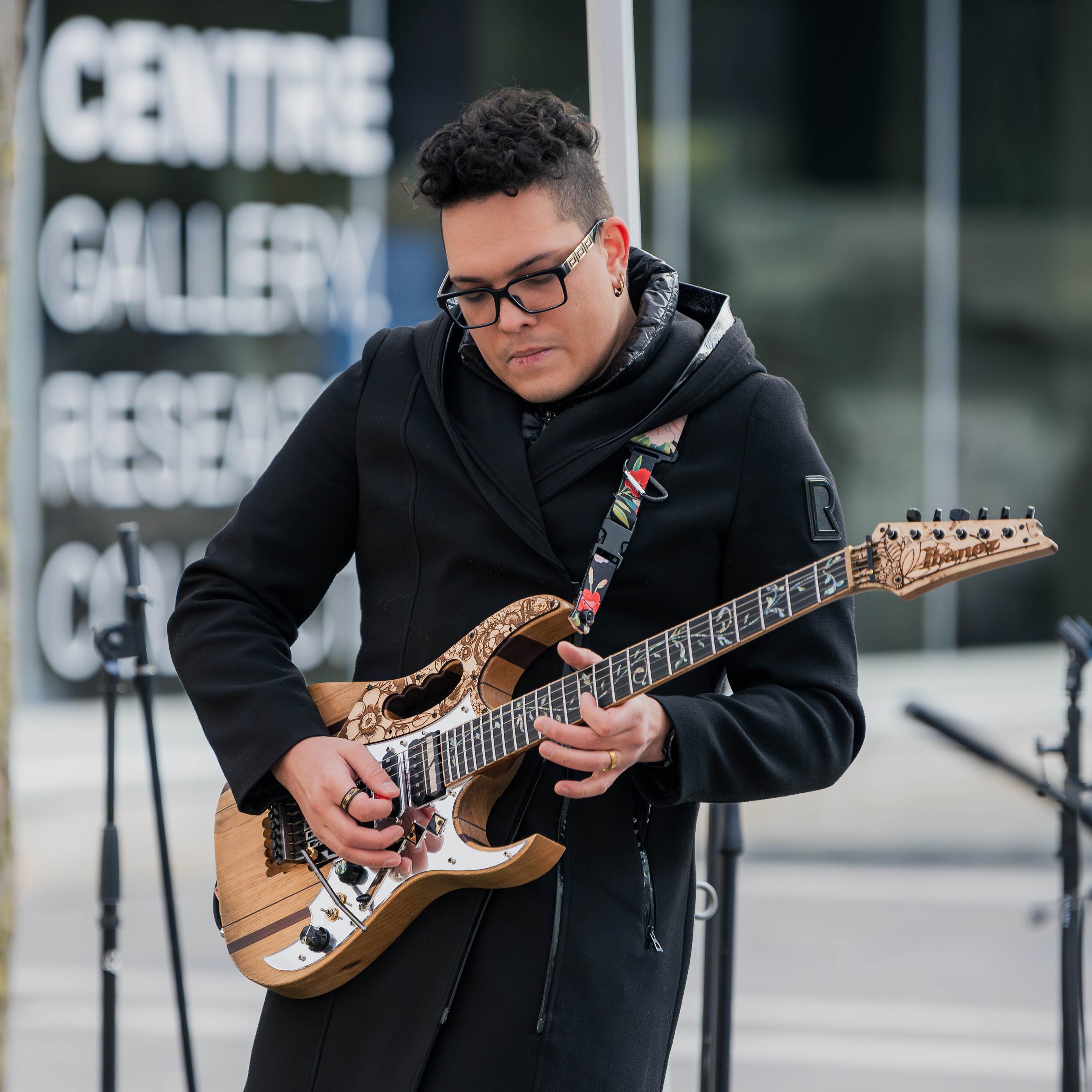 Michael playin the electric guitar.