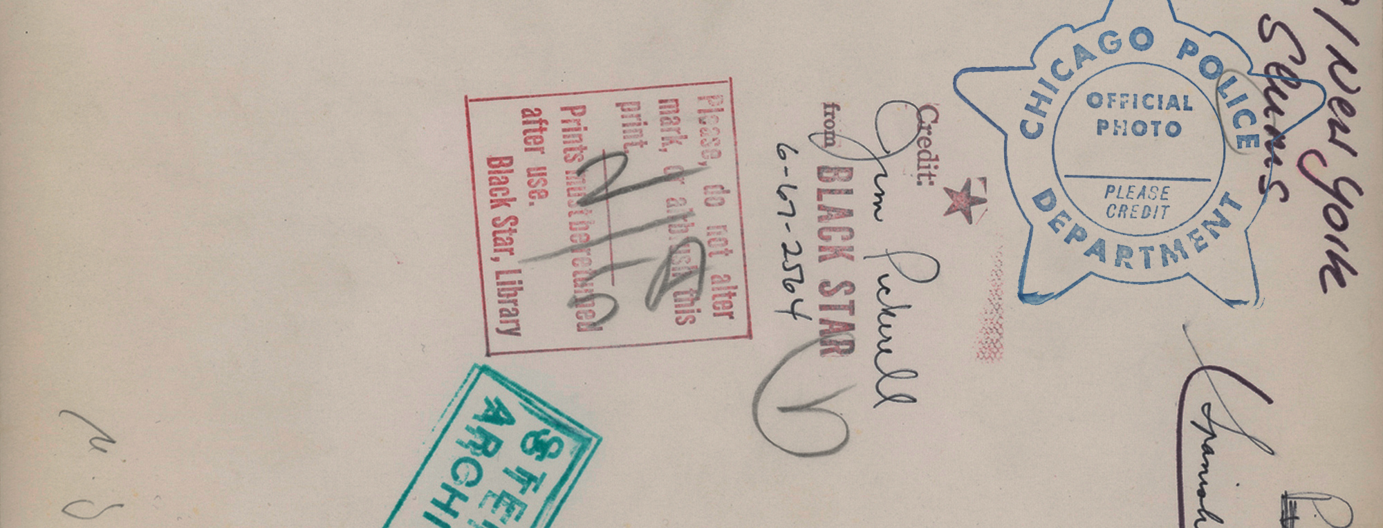 Back side of a vintage police document with stamps and registration numbers.
