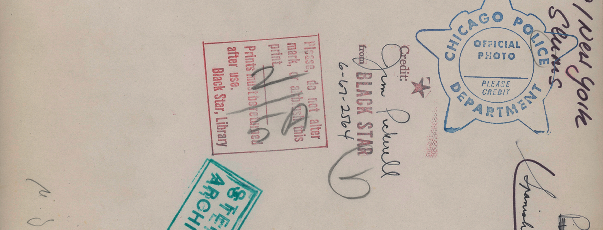 Back side of a vintage police document with stamps and registration numbers.