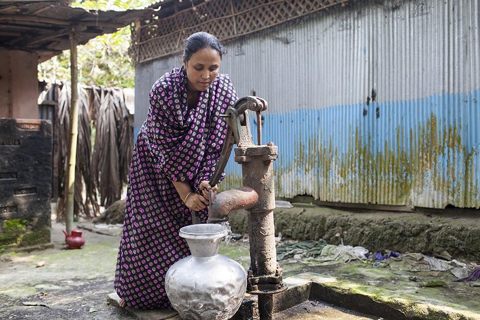 individual pouring water into container