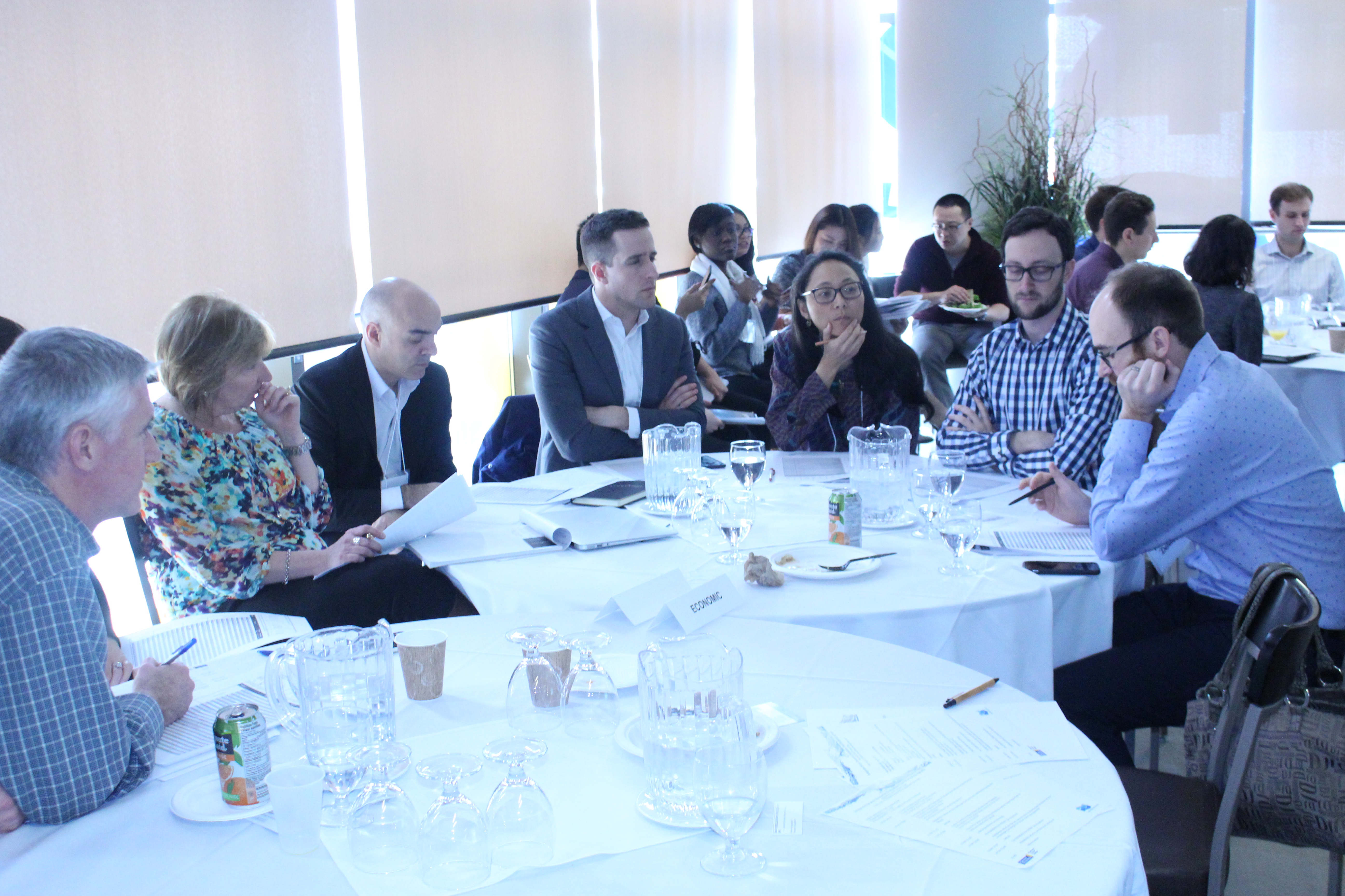 group of people sitting at round table networking