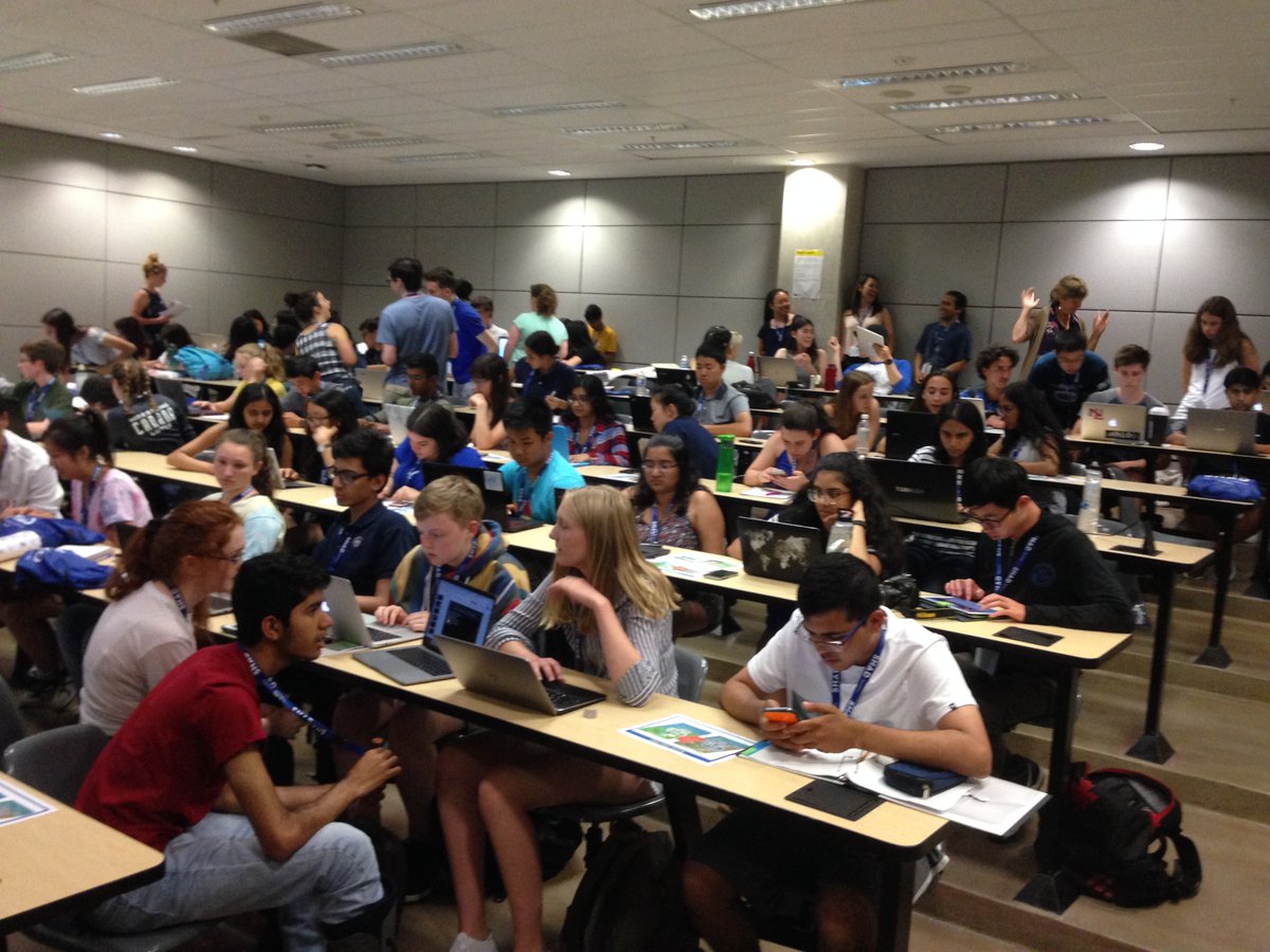 classroom of students with Lynda McCarthy walking through the back