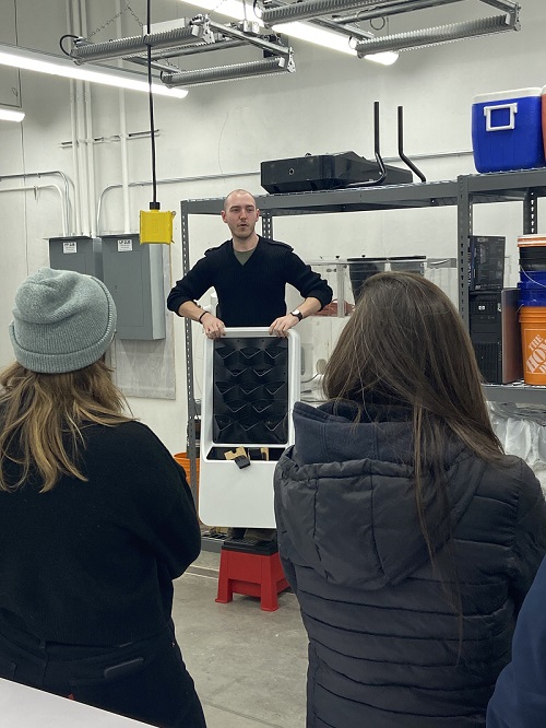 UW researcher showing green wall to students during tour