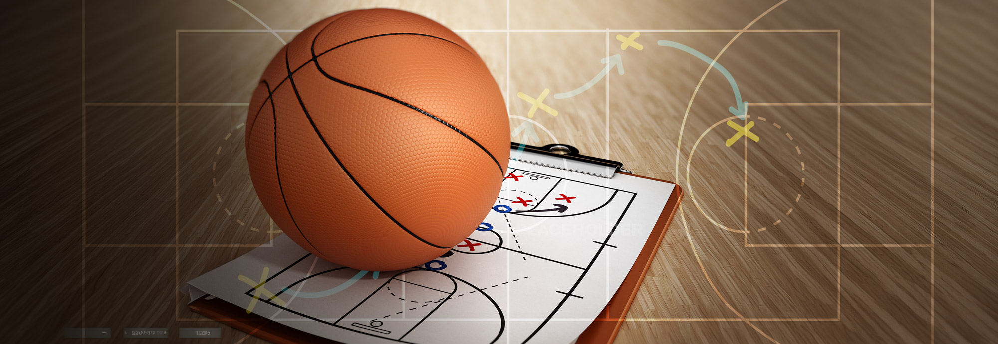 A basketball rests on a clipboard with a coaching diagram on a wooden floor.