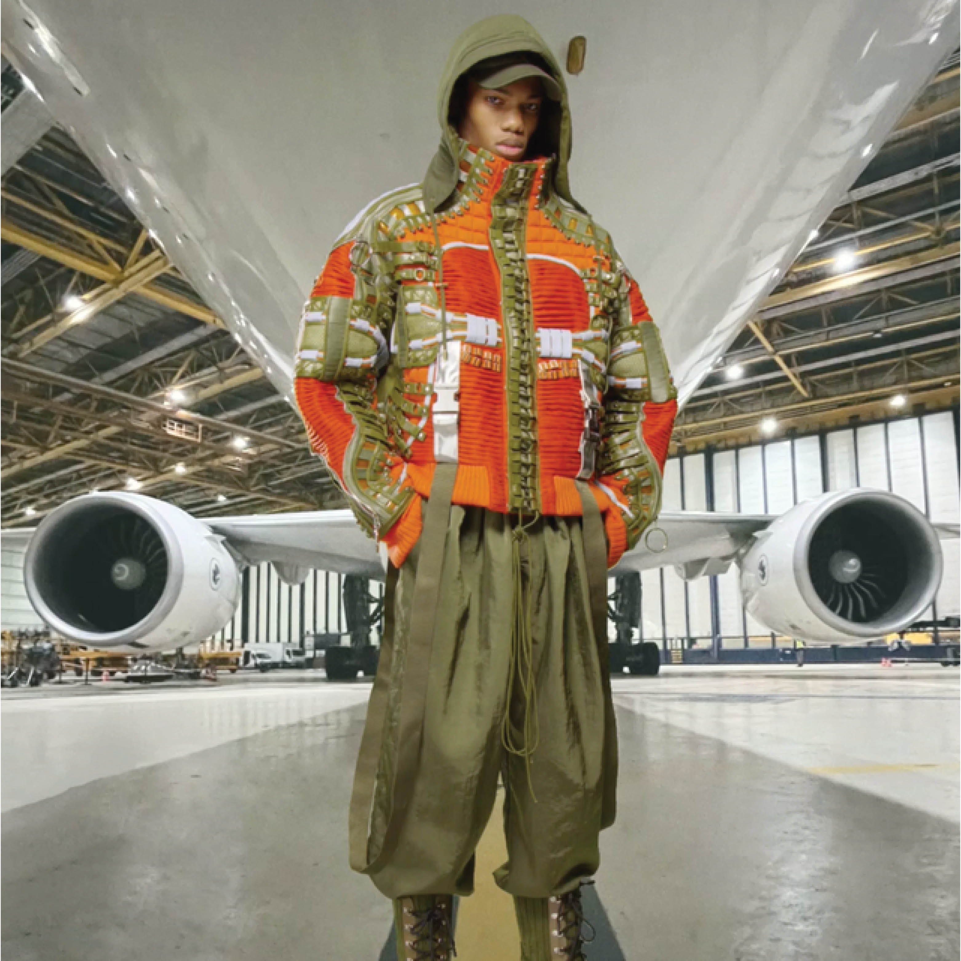 Balmain model in an airplane hanger.