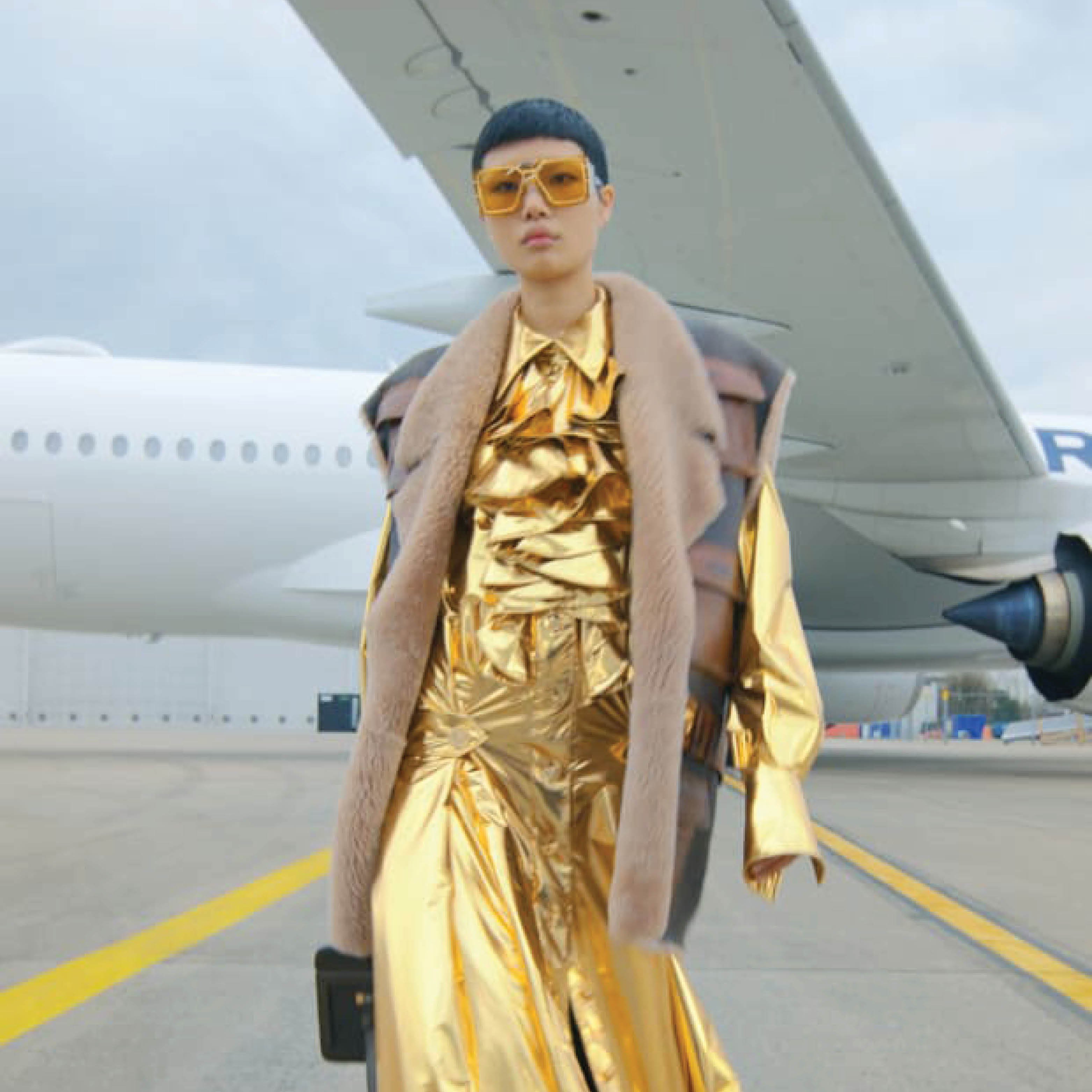 Balmain model on an airplane runway.