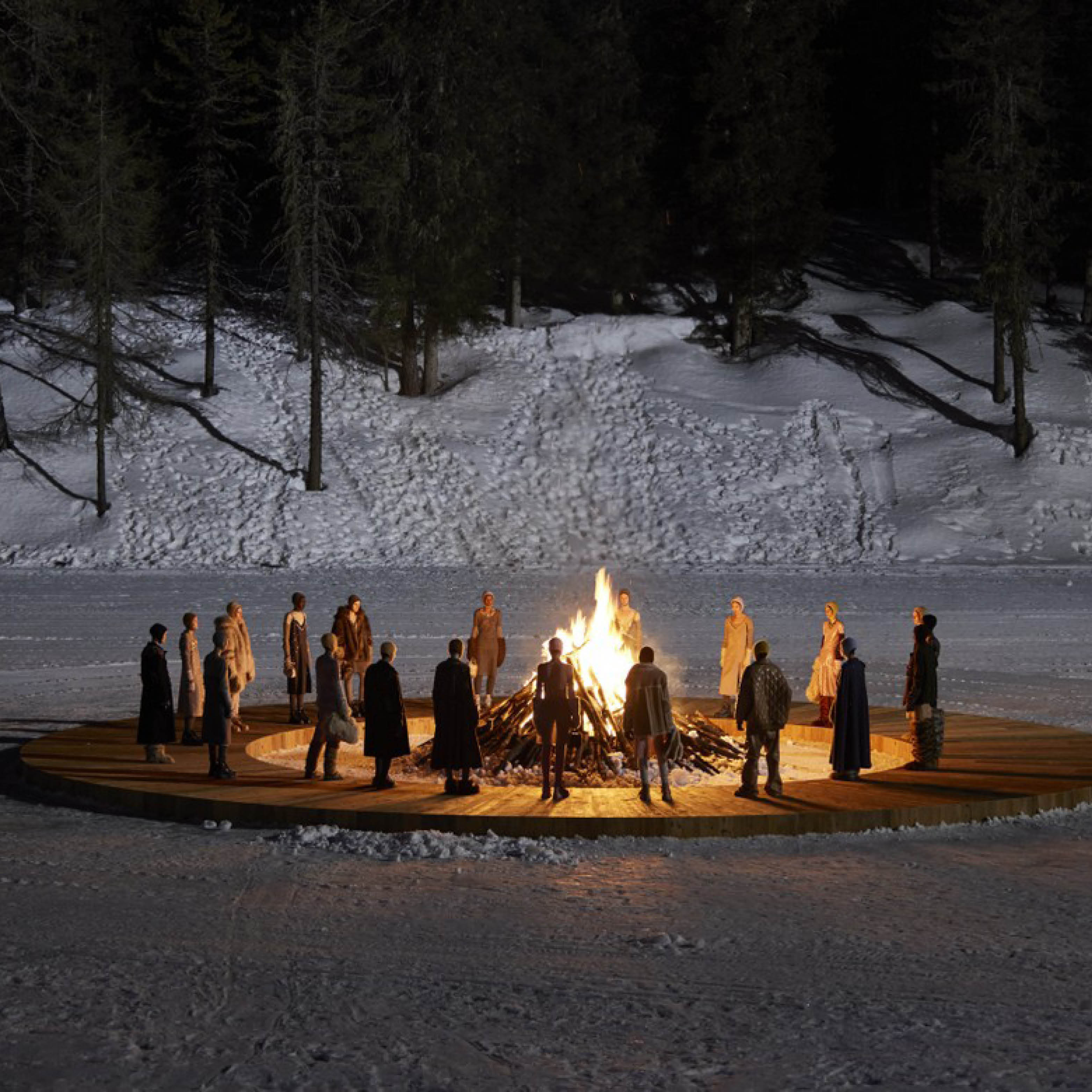 Miu Miu warming up around a fire.