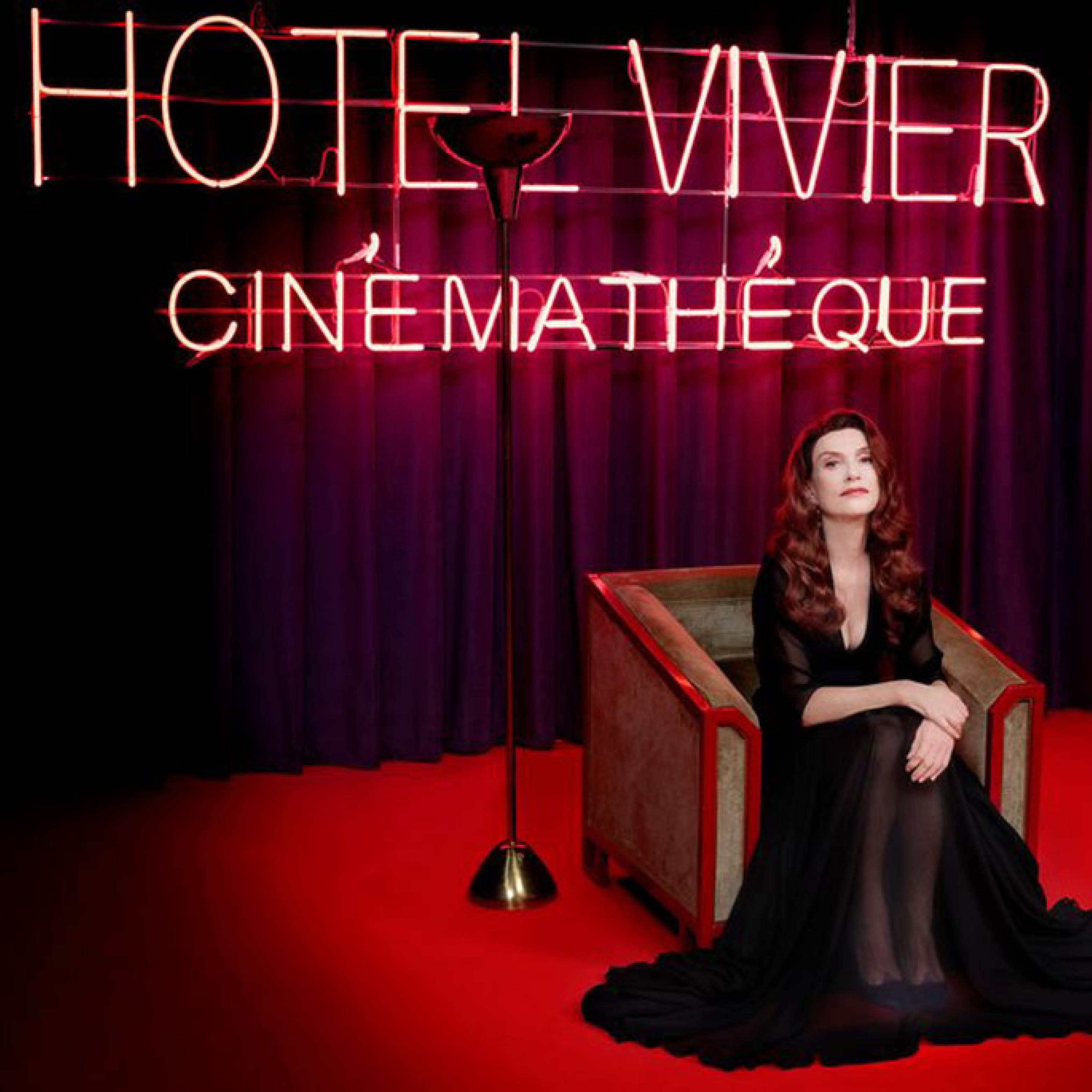 Isabelle Huppert in front of a red Hotel Vivier Cinémathèque sign.