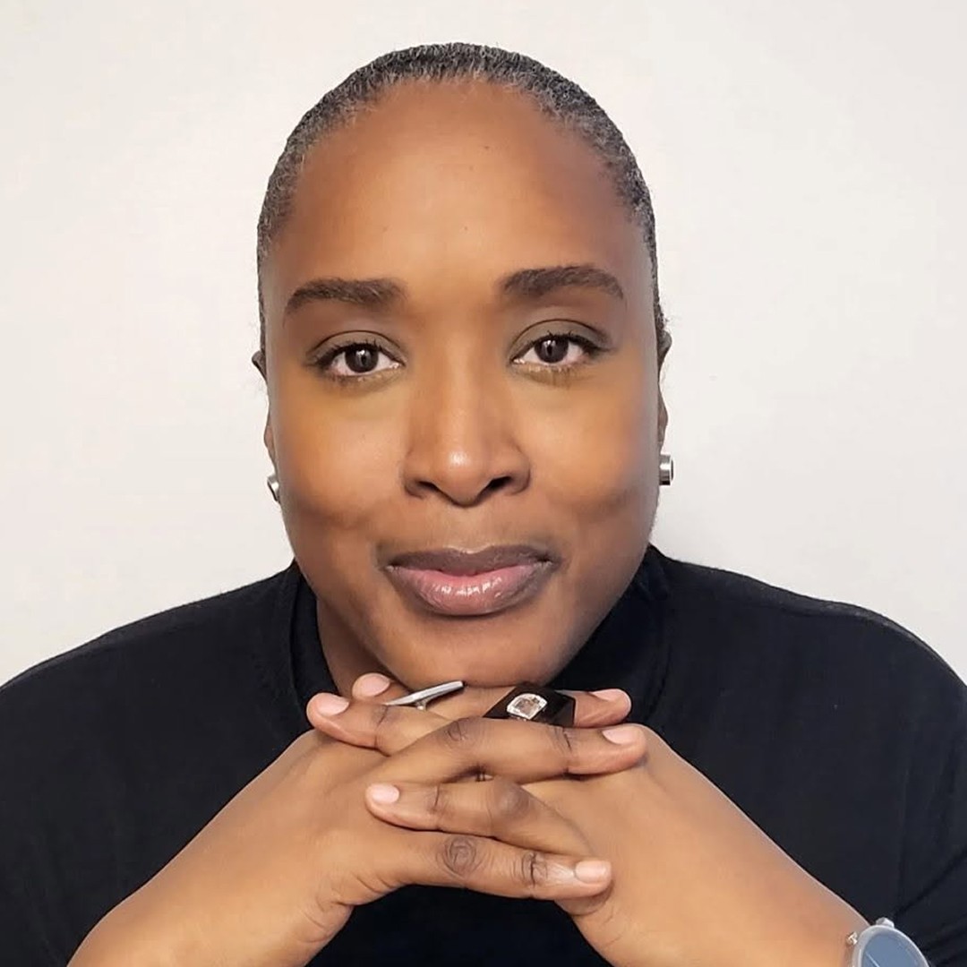 Jill Andrews wearing a black shirt and smiling at camera
