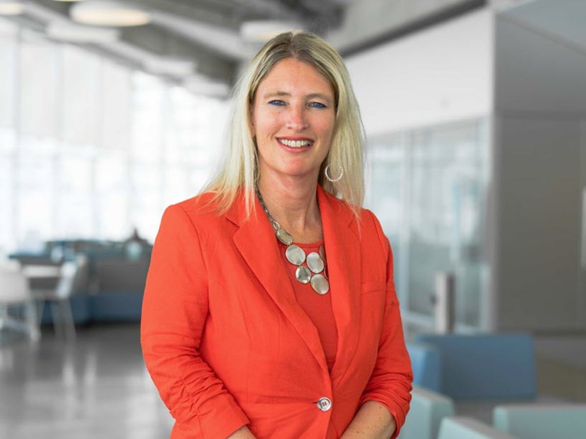Donna Bell, Secretary of Senate in a red blazer